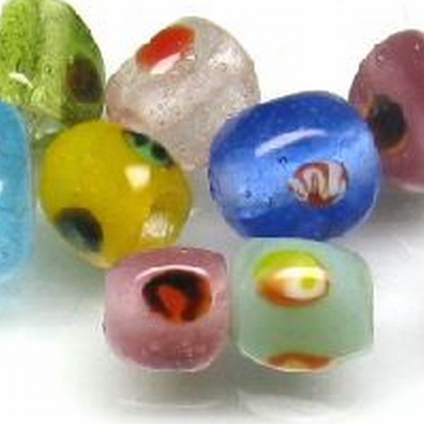 MUlti colored triangular glass beads made in Java, Indonesia.  These beads have relatively little variation in hape and size, even though they are made by hand using burner work in a tropical Javanese workshop. These beads have relatively little variation in shape and size, even though they are made by hand using burner work in a tropical Javanese workshop.